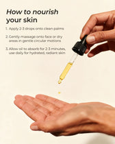 Hand holding a dropper with oil over another hand, demonstrating skincare routine.